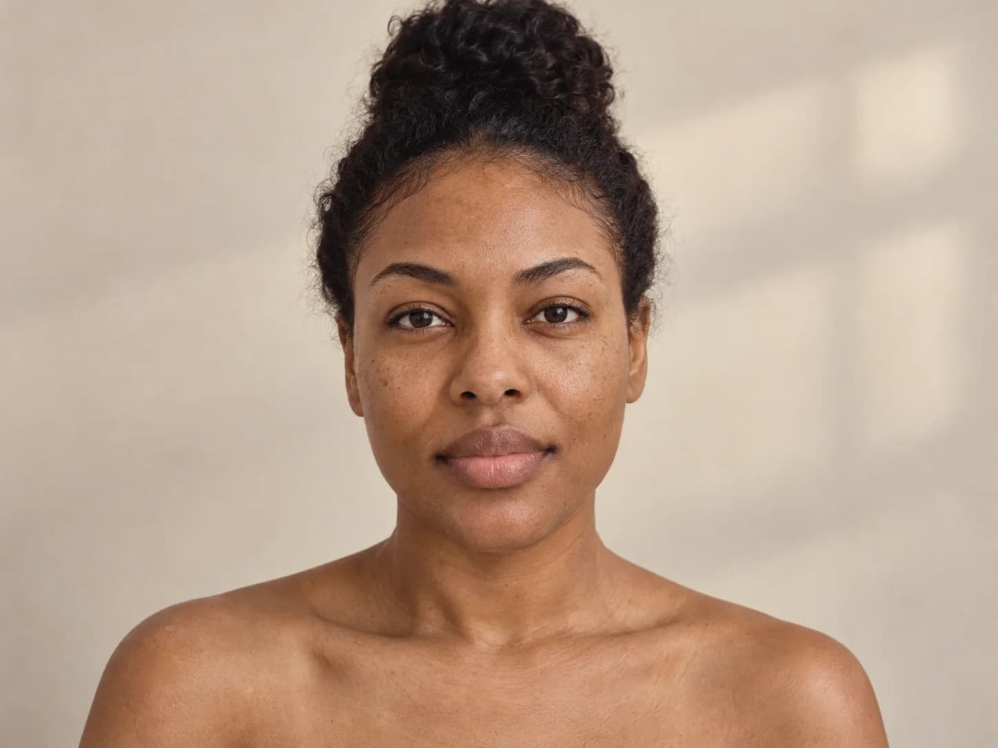 Adult facing the camera in soft daylight with natural skin texture visible